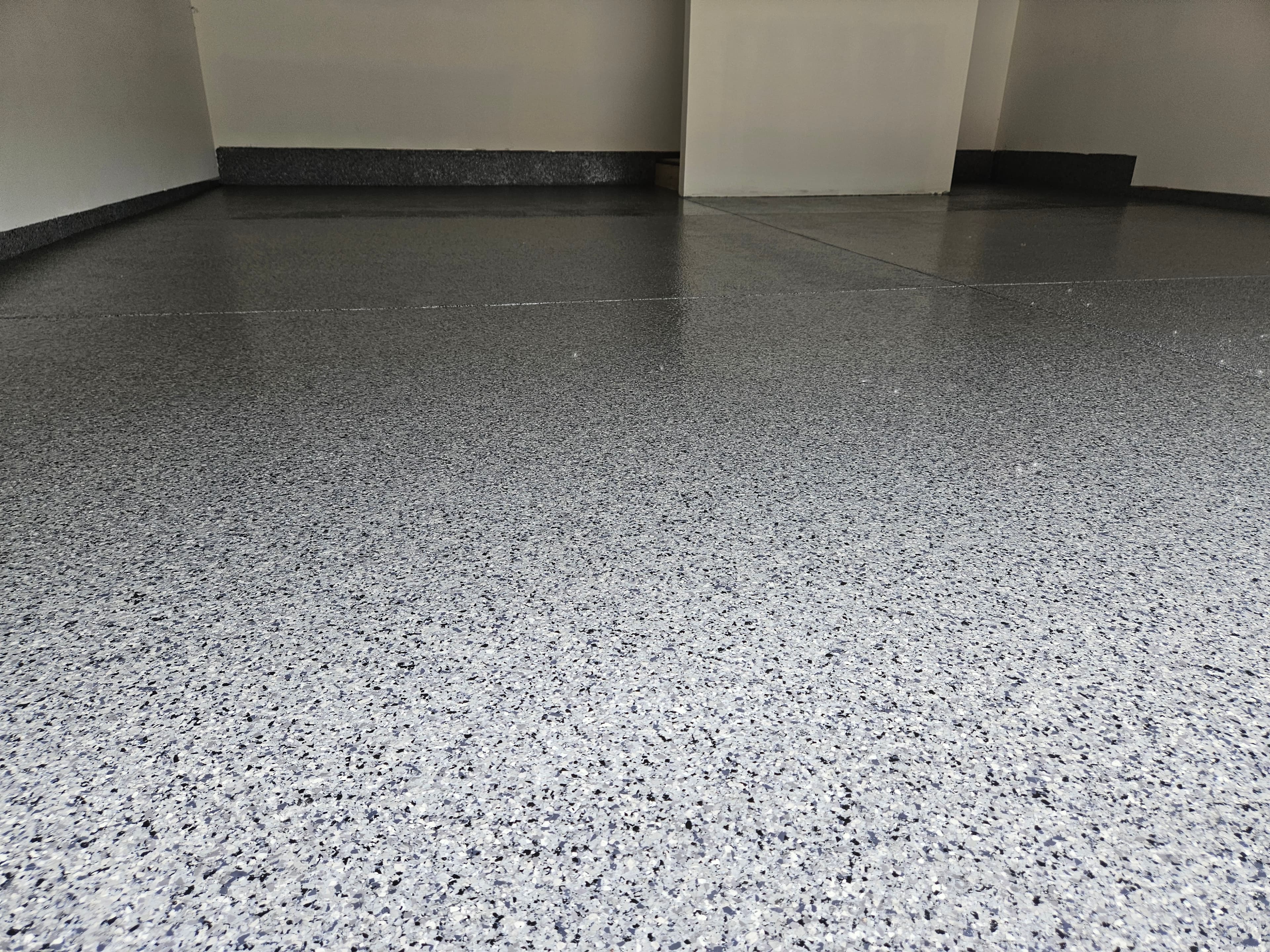 Garage floor transformed with a glossy epoxy coating in Windsor Ontario by Preferred Coating Solutions