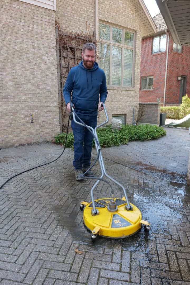 Joe Watling power washing an interlock driveway in Windsor Ontario